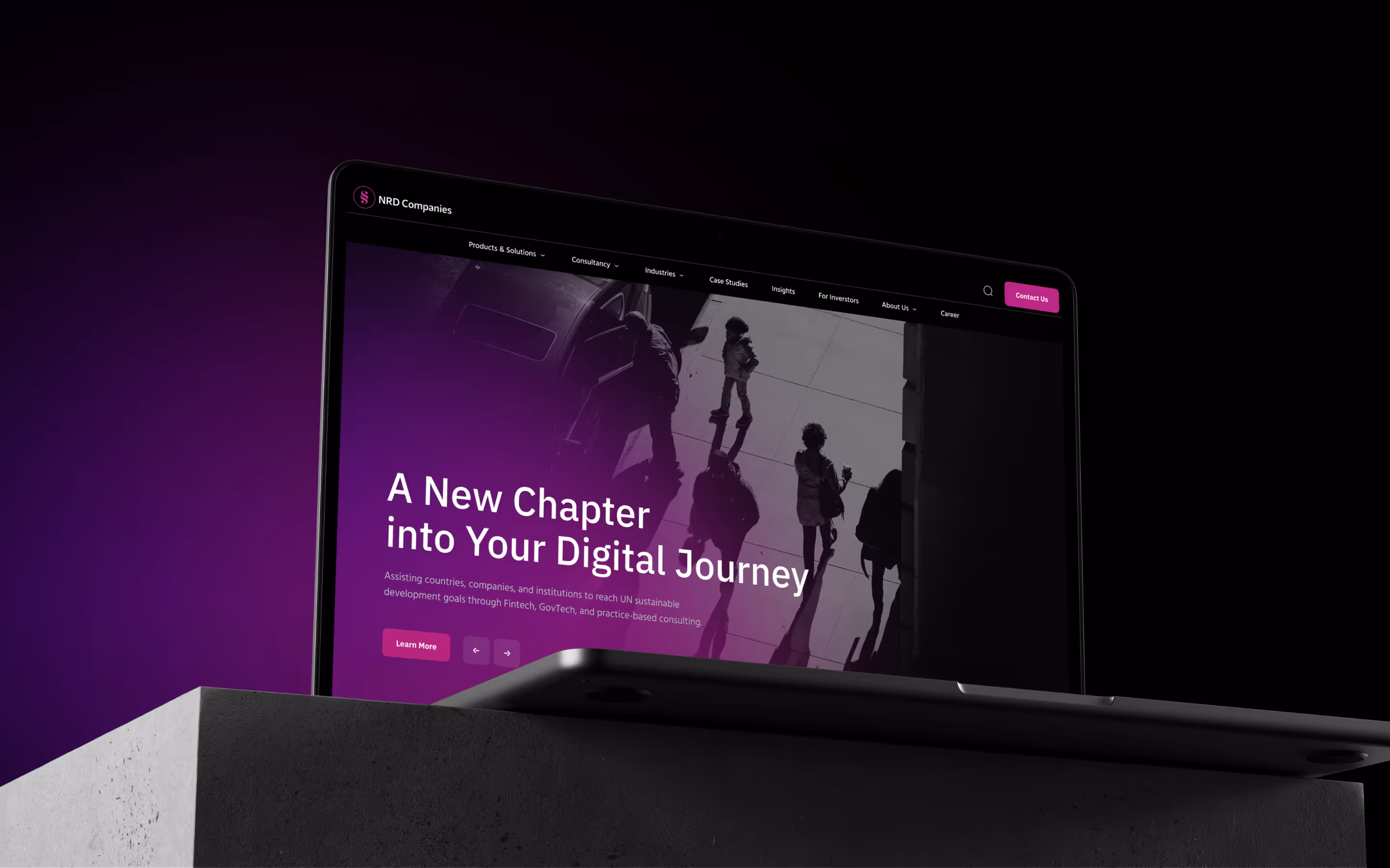 NRD Companies pradžios puslapis nešiojamajame - šūkis 'A New Chapter into Your Digital Journey' violetiniame gatvės kadre.